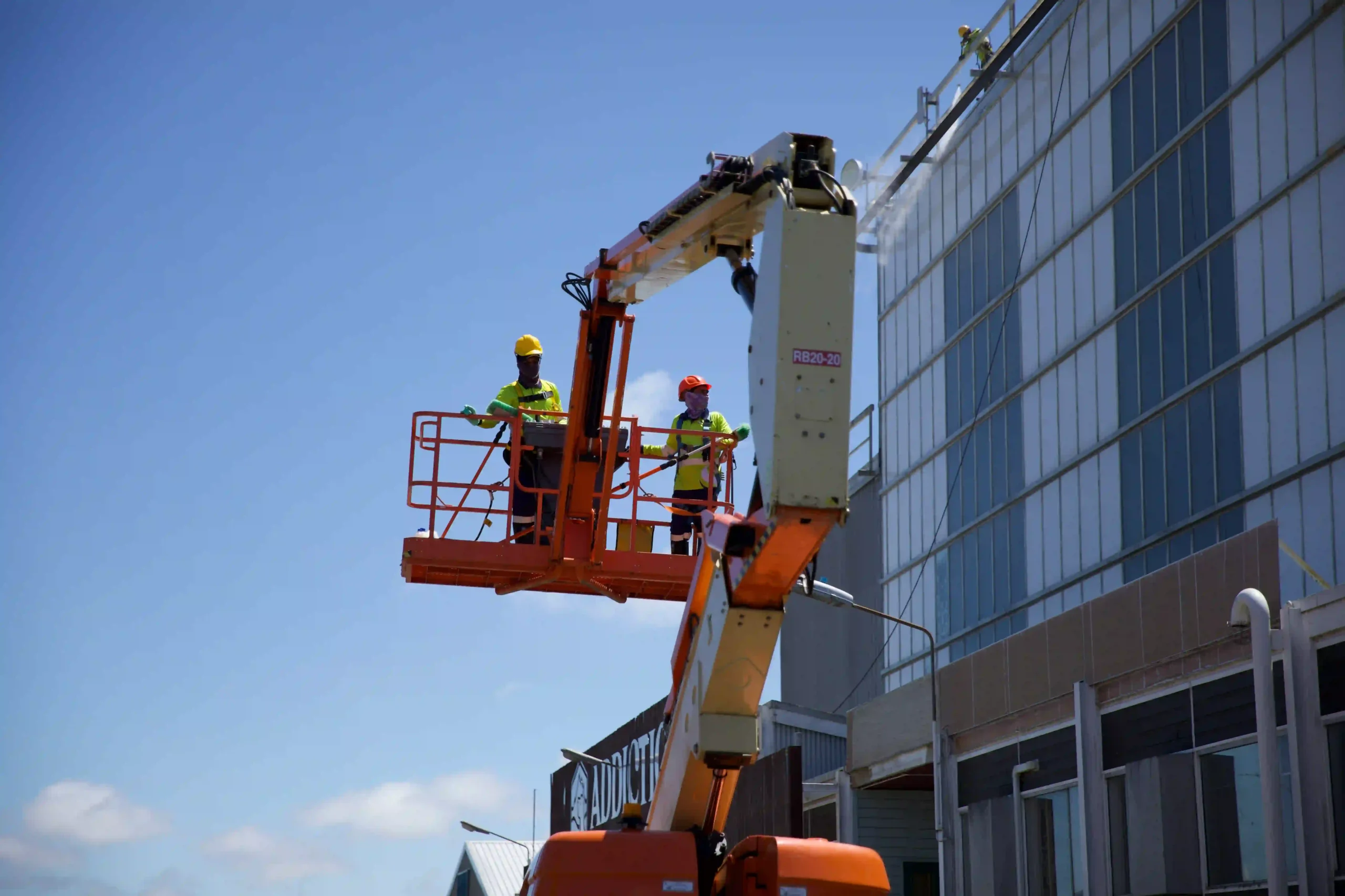 Abseiling window cleaning service in Hamilton showing technician using rope access equipment on a high-rise building