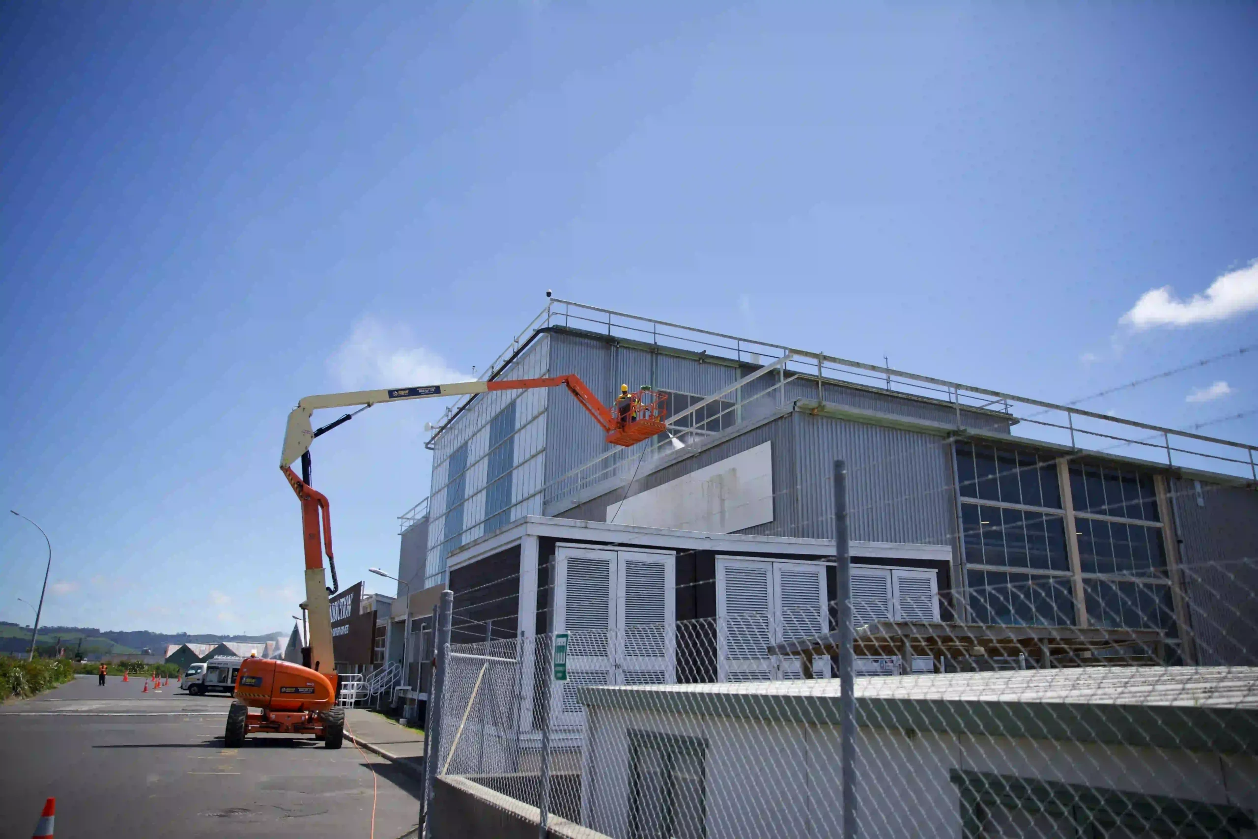 Commercial building exterior window cleaning in Hamilton using safe rope access methods for hard-to-reach glass